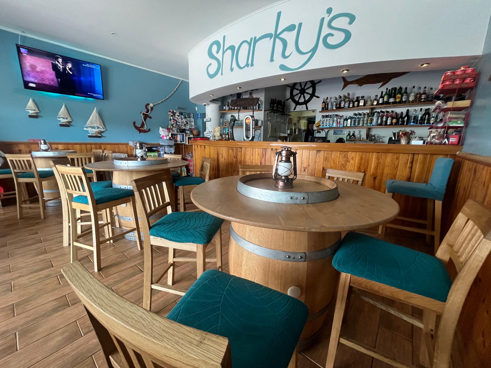 Interior of Sharky's Bar with barrel tables
